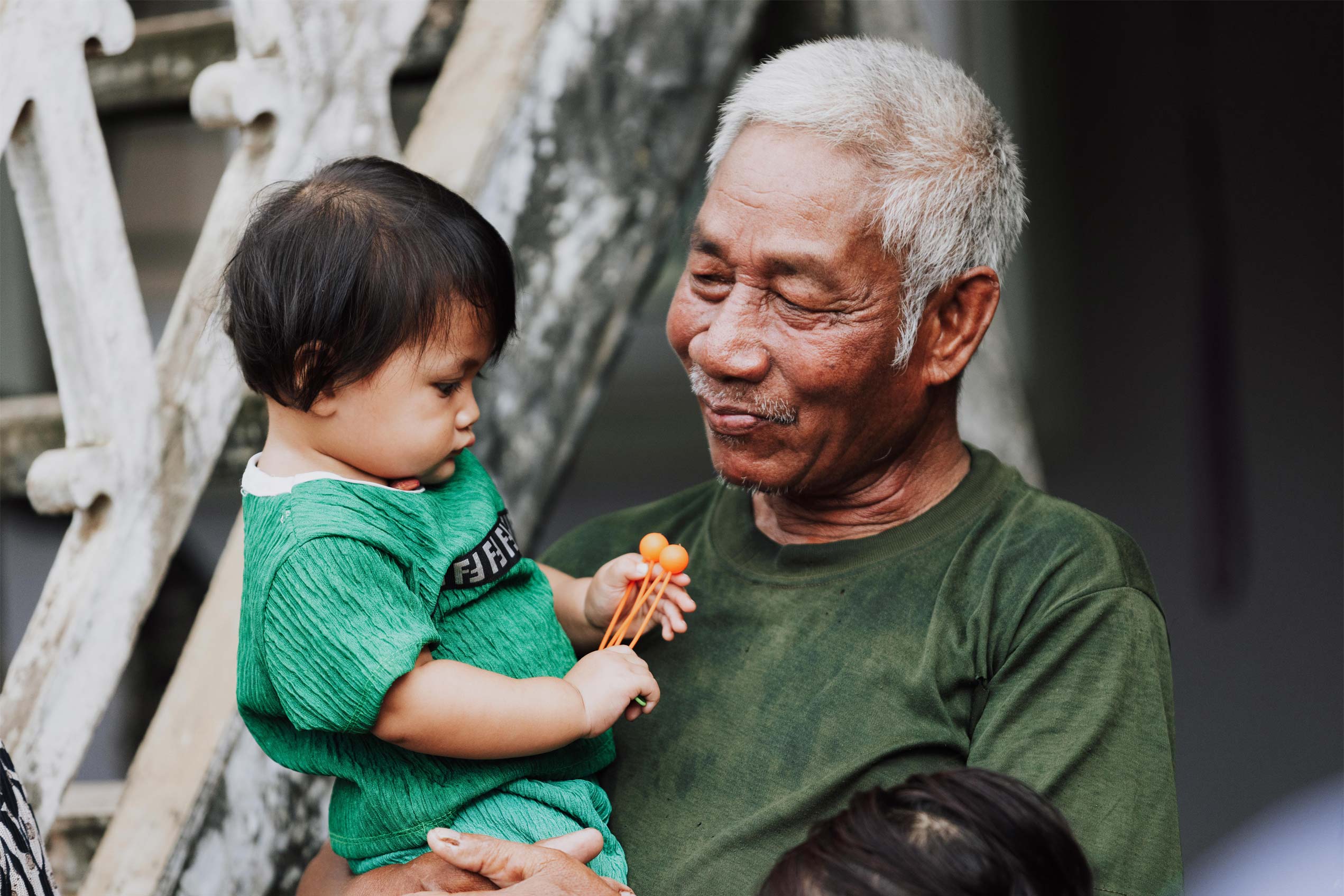 man from cambodia holds a child