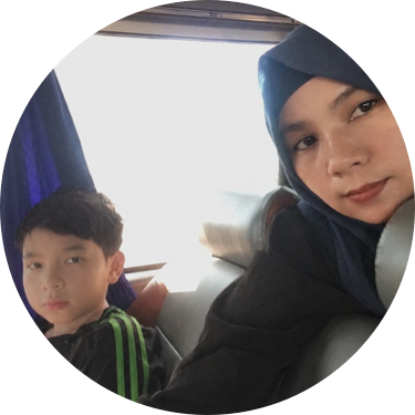 Sreyphass and her son Imron sitting together on a bus or train