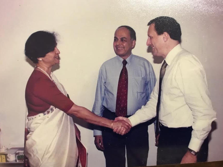 Partnering with Novartis. A lady and a man shake hands.